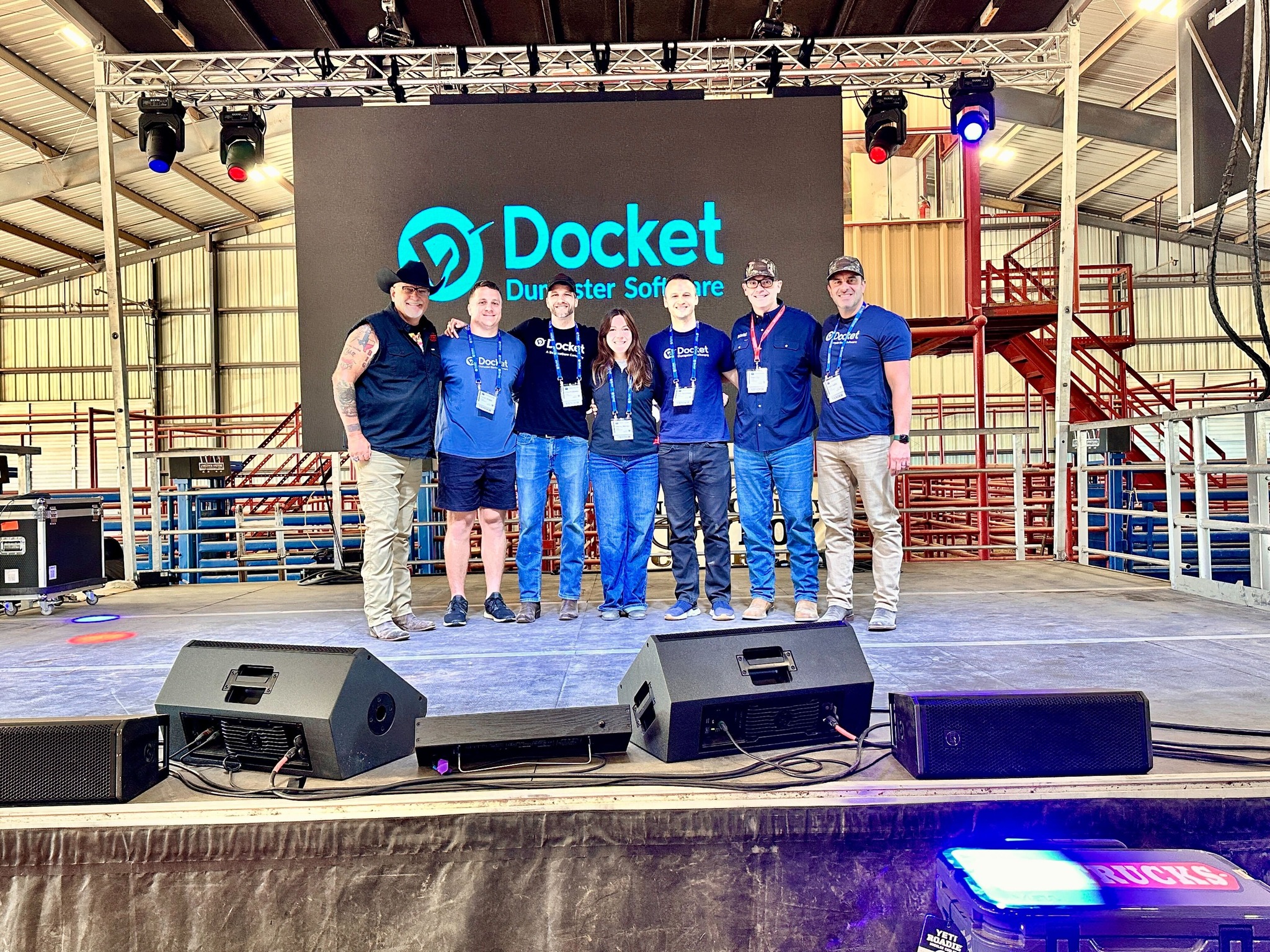 Speaker on stage at the Dumpster Expo with packed crowd